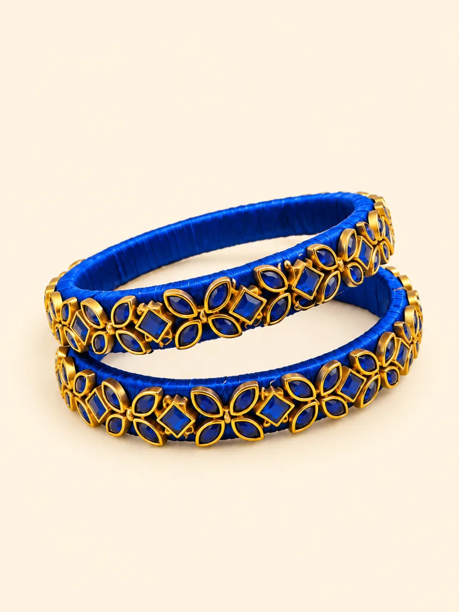 Royal Blue Floral Designer Bangle Pair — Matching pair of two royal blue designer bangles with a blue base and gold-tone floral and loop detailing.
