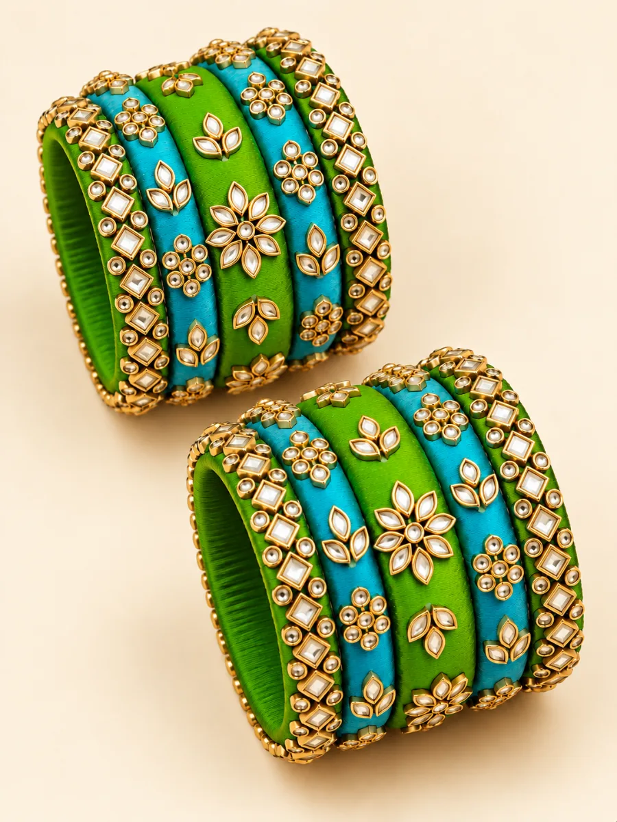 Parrot Green & Turquoise Kundan Designer Bangles Set — Elegant handmade bangles featuring parrot green and turquoise thread-wrapped bands with gold-toned floral, leaf, and geometric embellishments.