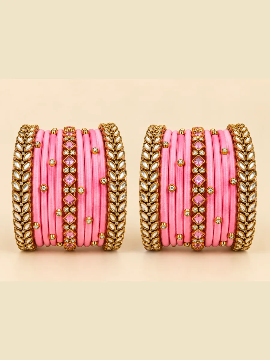 Pink Silk Thread Kundan Designer Bangles — Elegant pink silk thread bangles featuring gold-toned leaf motifs, white Kundan stones, and sparkling crystal embellishments.