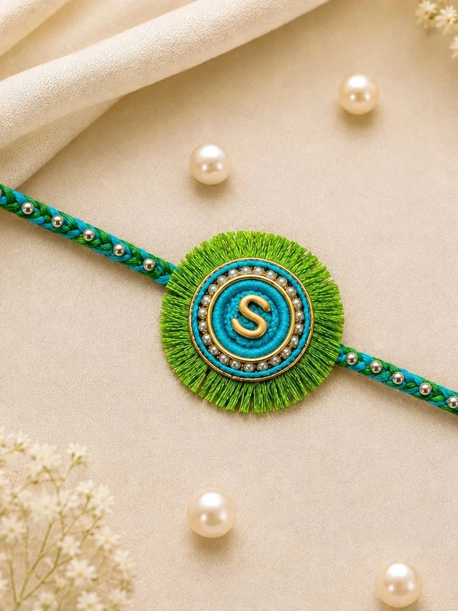 Kids Emerald Rockie — Kids-themed decorative Rakhi with a green thread and circular green-blue centerpiece.