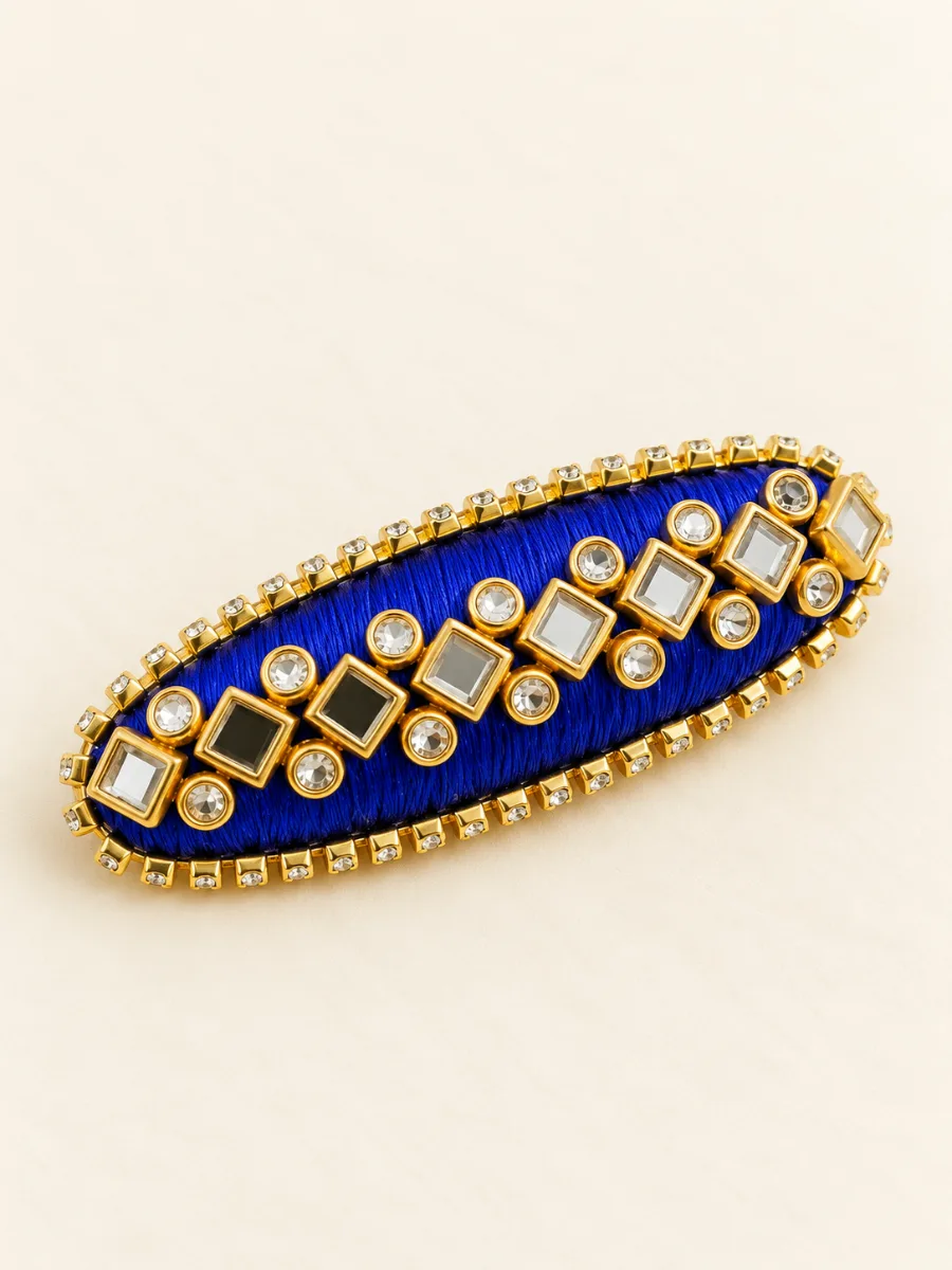 Royal Blue Designer Stone Saree Pin — Handmade royal blue fabric saree pin with decorative clear stones and detailed gold-tone edging.